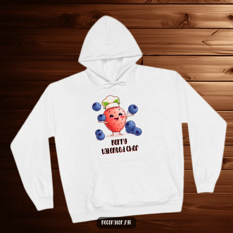 Funny strawberry chef hoodie: a strawberry chef juggles blueberries, offering warm and humorous kitchen vibes.