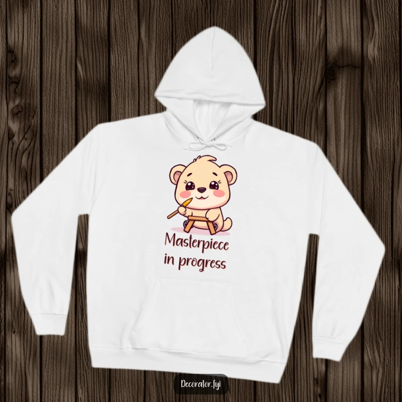 Funny hoodie with a joyful character painting while balancing a tiny paintbrush on its nose, offering comfort and a chuckle for art fans.