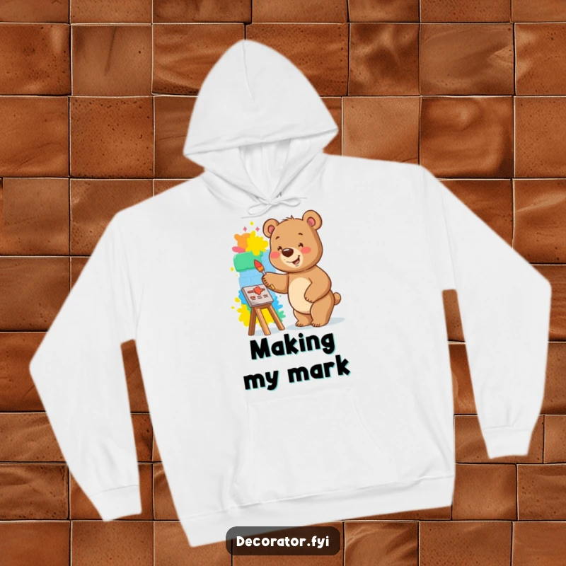 Funny bear hoodie showing a smiling bear happily painting a vibrant mural on a small wall, ready to create.