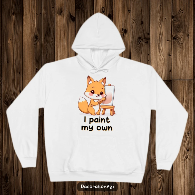 Funny hoodie showcasing a smiling fox with a paintbrush, ready to create a masterpiece on a blank canvas.